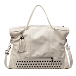 Beige handbag with studded detail and tassel