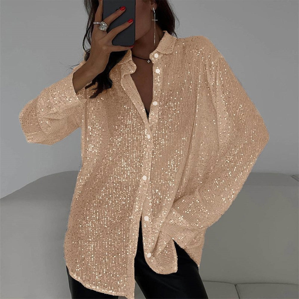 Beige sequin blouse worn by a person against a neutral background