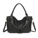 Black handbag with a strap on a white background
