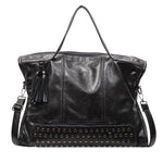 Black leather handbag with studded detail and tassel on a white background