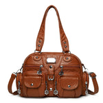 Brown handbag with decorative elements on a white background