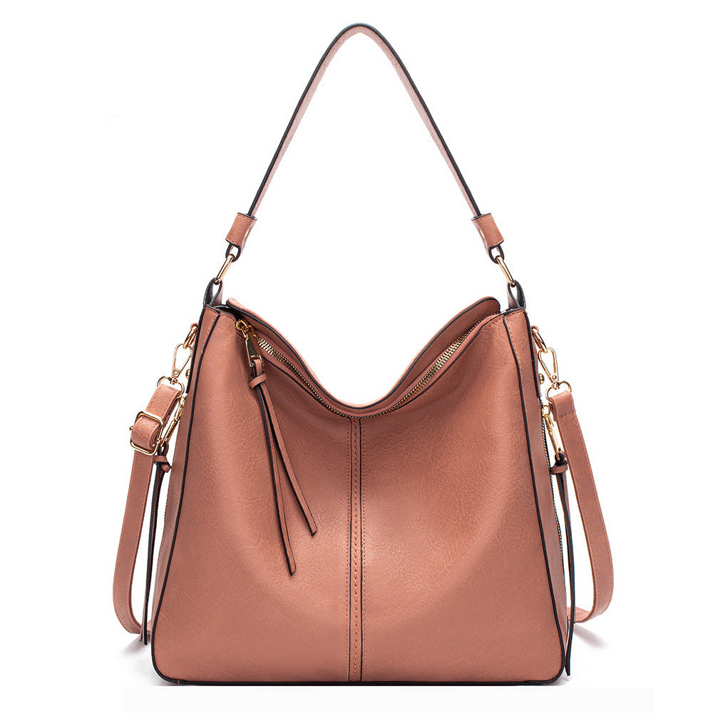 Brown leather handbag with gold accents