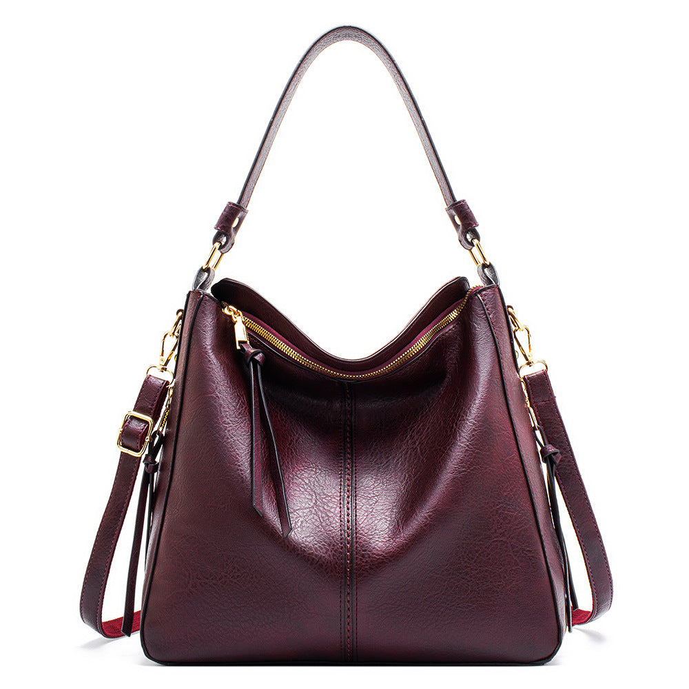 Burgundy handbag with gold accents