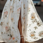 Close-up of flare sleeve, floral print, and high slit hem