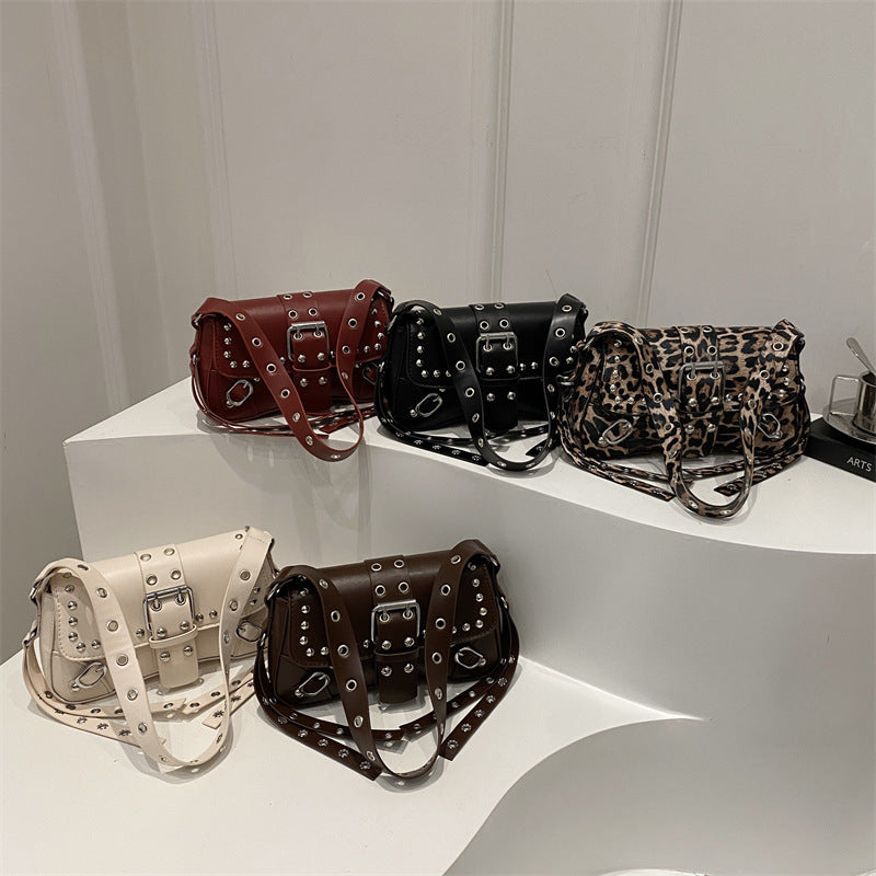 Collection of handbags on a white surface with a neutral background