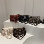 Collection of handbags on a white surface with a neutral background