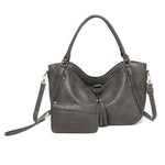 Gray handbag with a shoulder strap on a white background