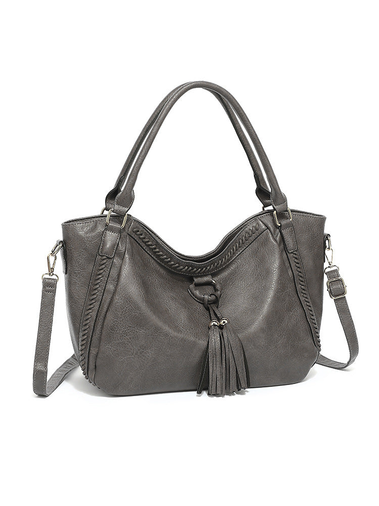 Gray handbag with a strap on a white background