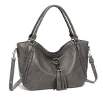 Gray handbag with a strap on a white background