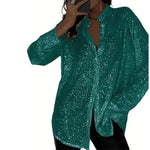 Green sequin blouse worn by a person on a white background