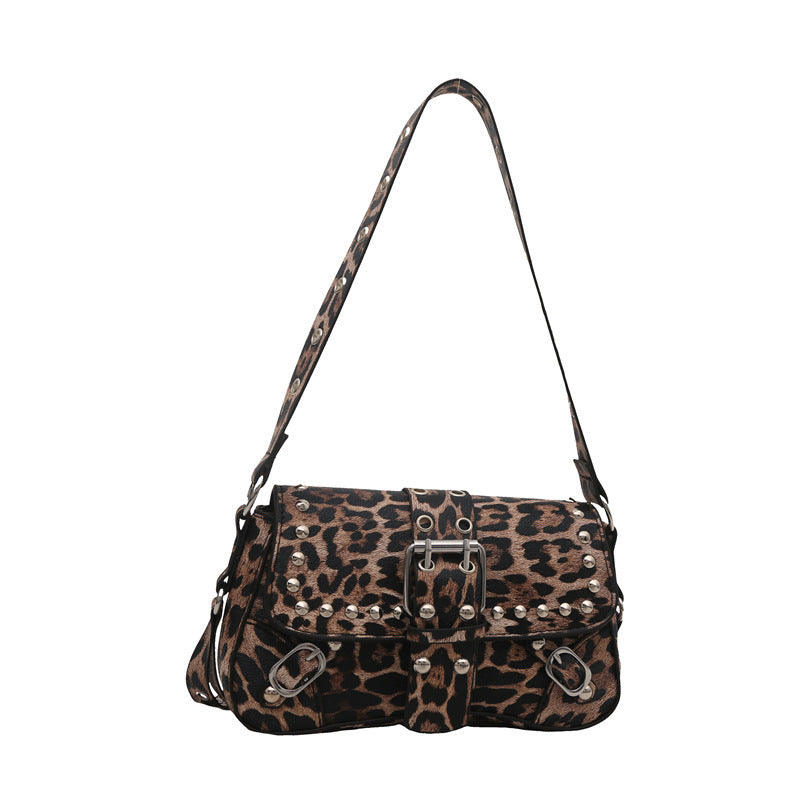 Leopard print handbag with silver studs on a white background