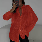 Person wearing a red textured shirt with a neutral background
