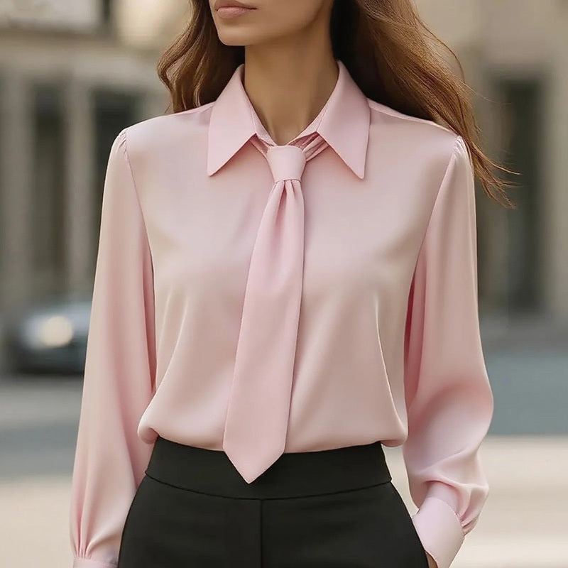 Pink blouse with a tie detail worn by a person