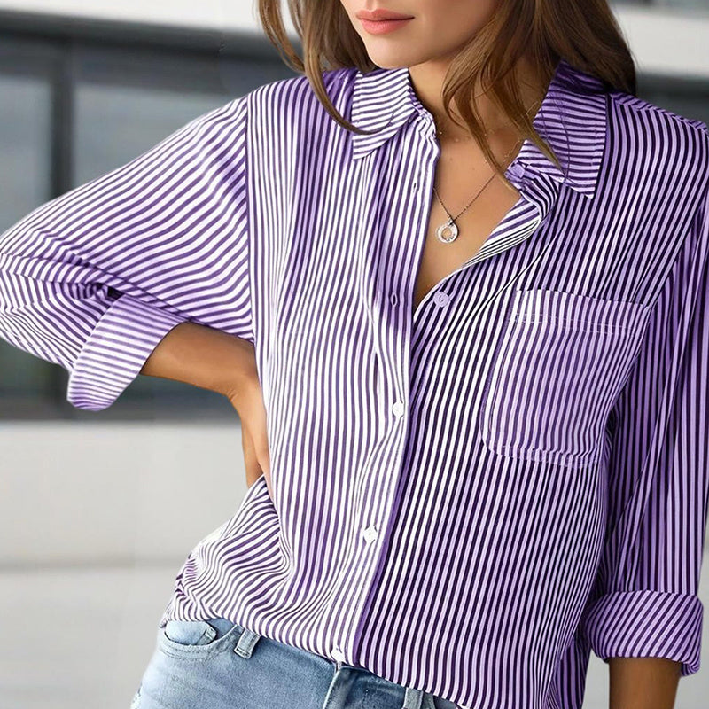 Purple and white striped shirt worn by a person with a blurred background