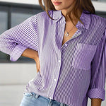 Purple and white striped shirt worn by a person with a blurred background