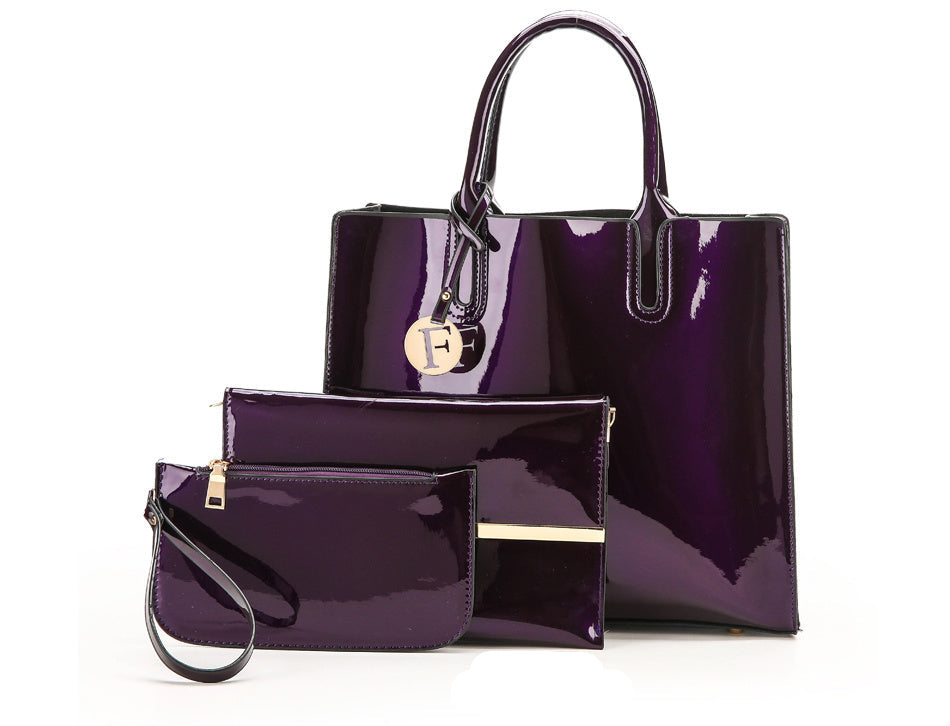 Purple handbag and matching pouch on a white background