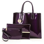 Purple handbag and matching pouch on a white background