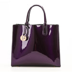 Purple handbag with a gold tag on a white background