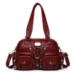Red handbag with multiple pockets and straps on a white background