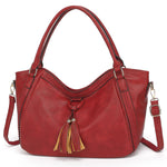 Red handbag with tassels on a white background