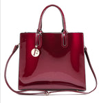 Shiny red handbag with a visible brand logo on a white background