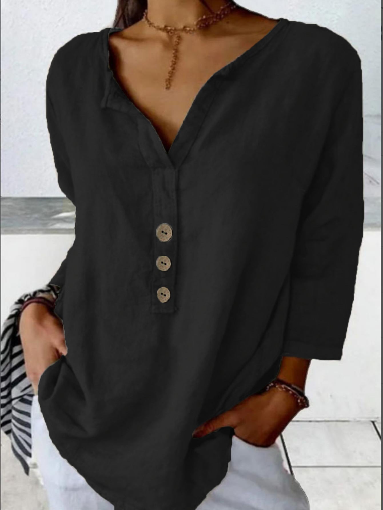 Solid color button-down shirt displayed flat with accessories