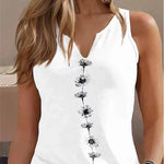 White sleeveless top with black floral patterns worn by a person.