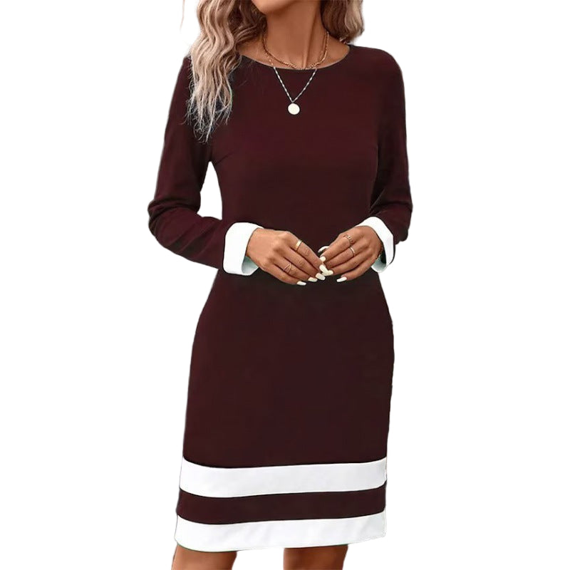 Woman wearing a burgundy dress with white trim in an urban setting