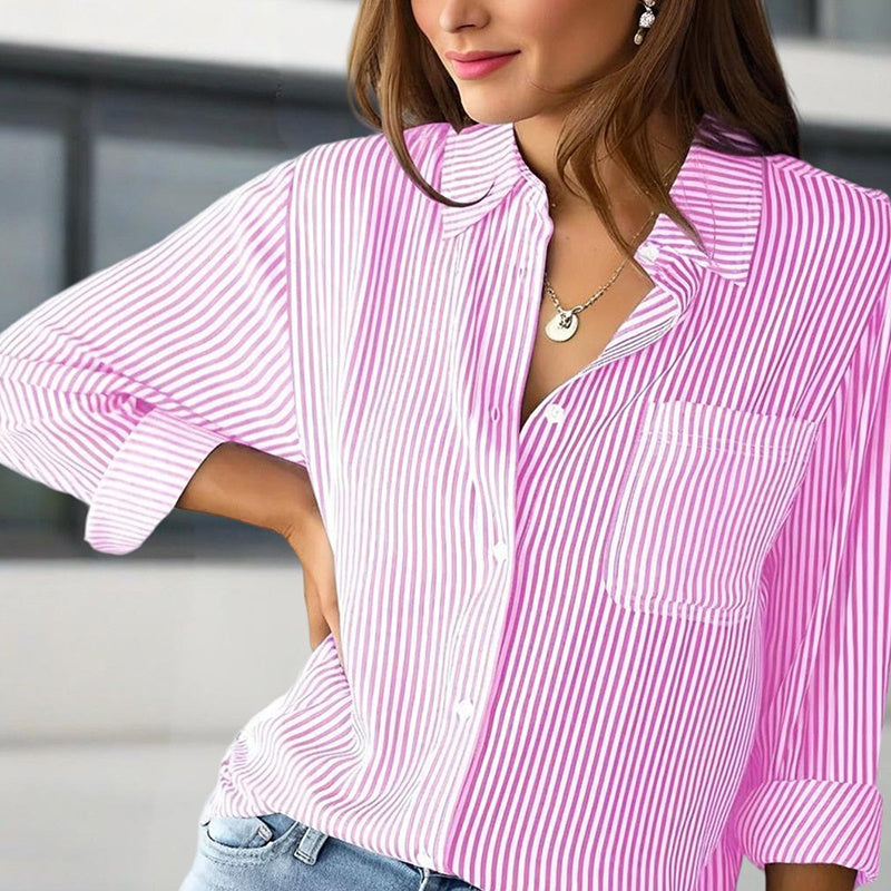 Woman wearing a pink and white striped shirt with a blurred background